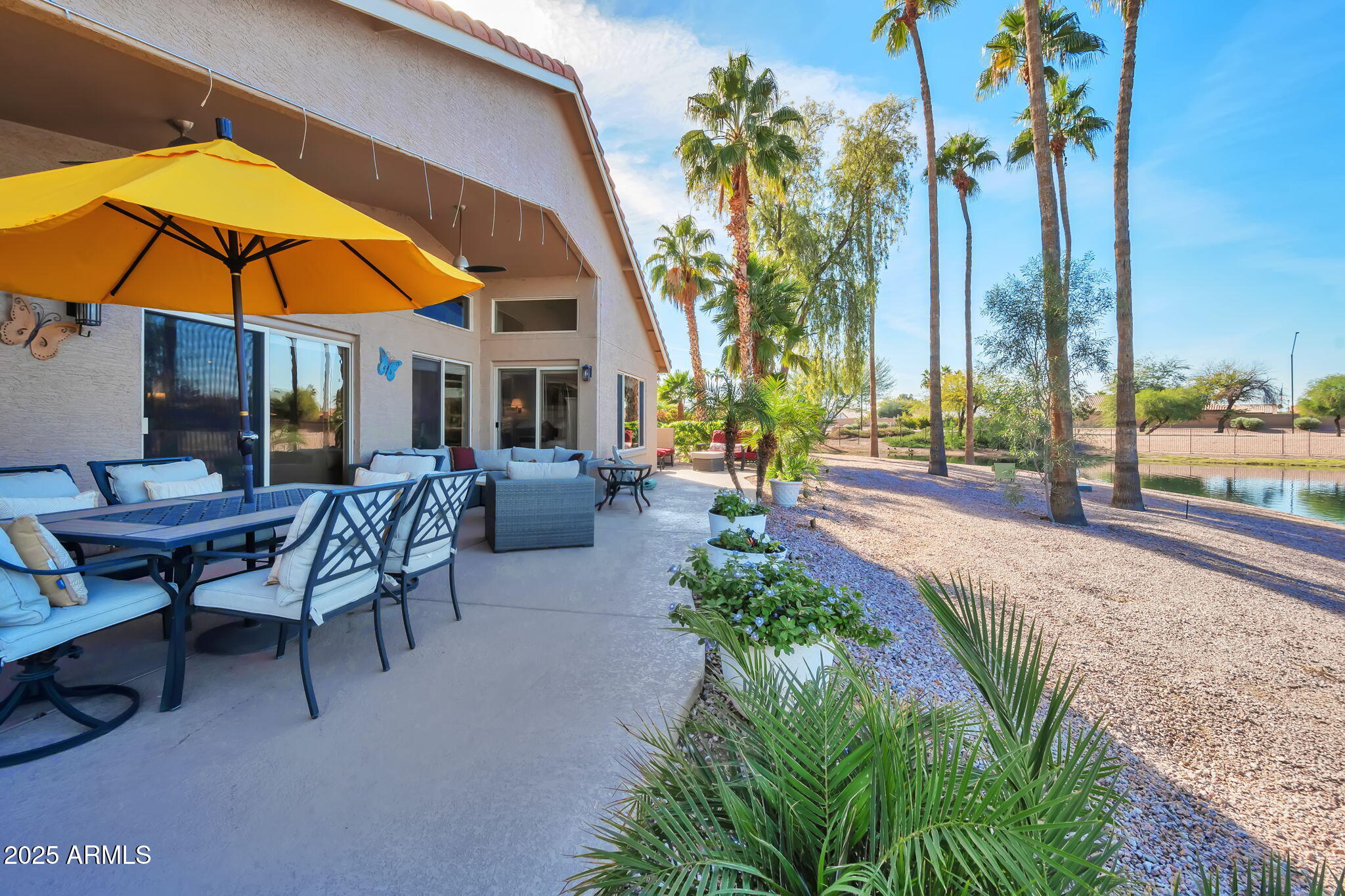 15460 West Merrell Street Goodyear, AZ 85395 - Photo 30 of 30 a view of a swimming pool with a table and chairs under an umbrella
