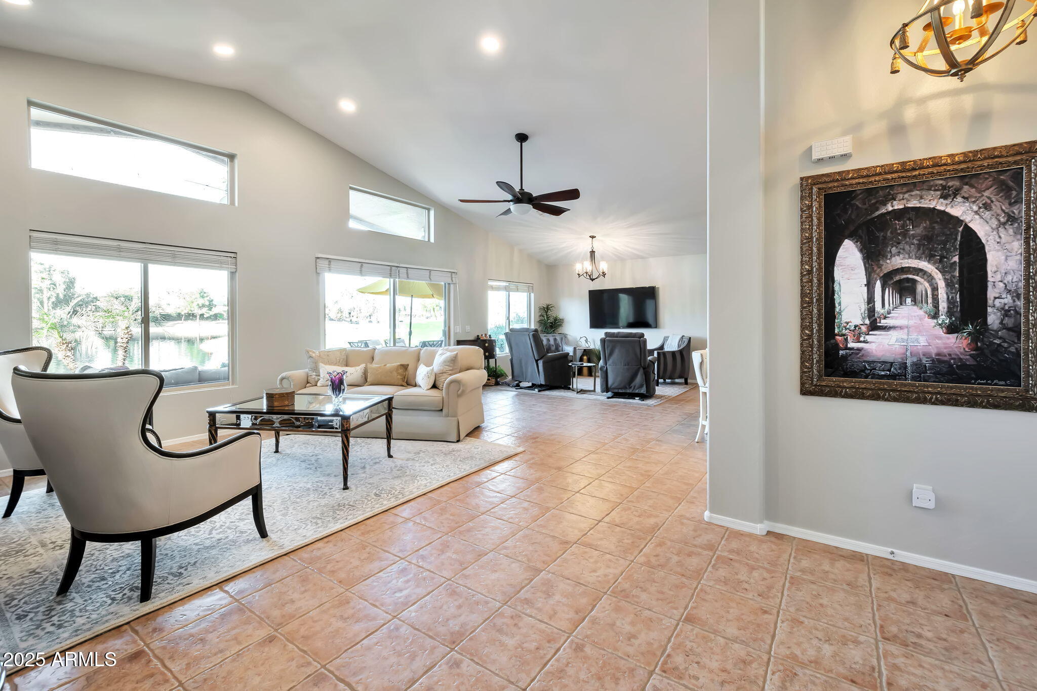 15460 West Merrell Street Goodyear, AZ 85395 - Photo 5 of 30 a living room with furniture a fireplace and a large window