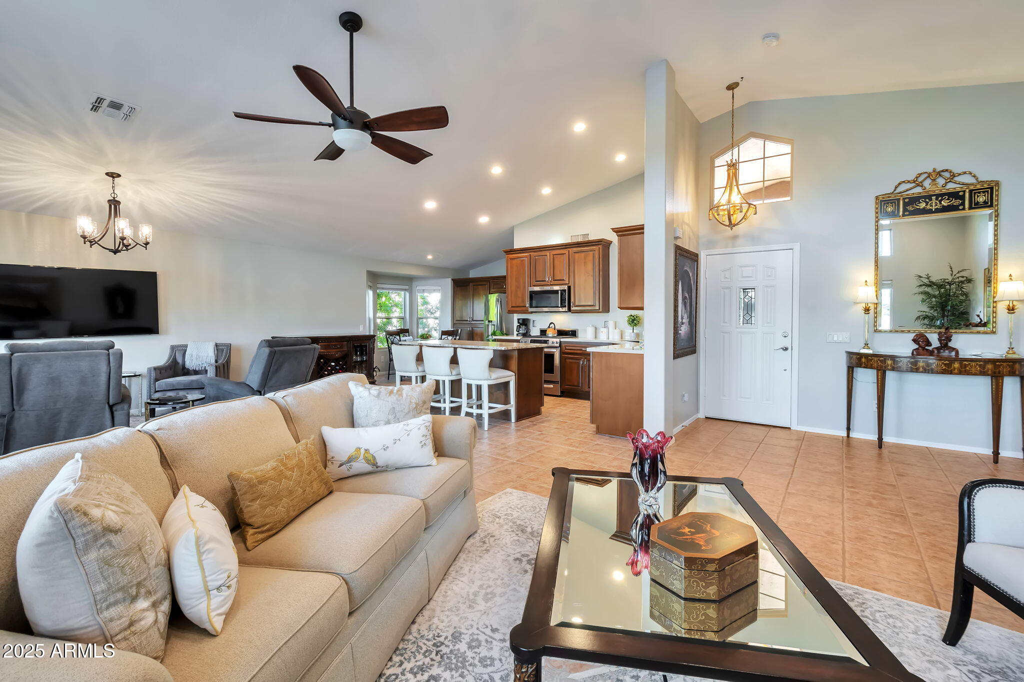 15460 West Merrell Street Goodyear, AZ 85395 - Photo 6 of 30 a living room with furniture kitchen view and a chandelier