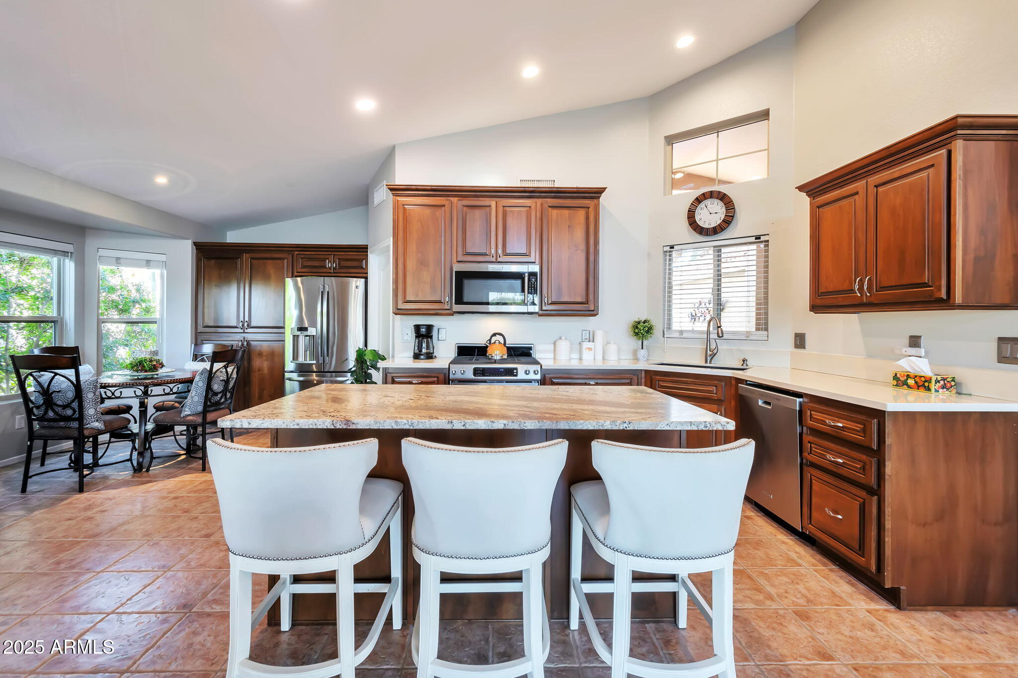 15460 West Merrell Street Goodyear, AZ 85395 - Photo 8 of 30 a kitchen with a dining table chairs and window