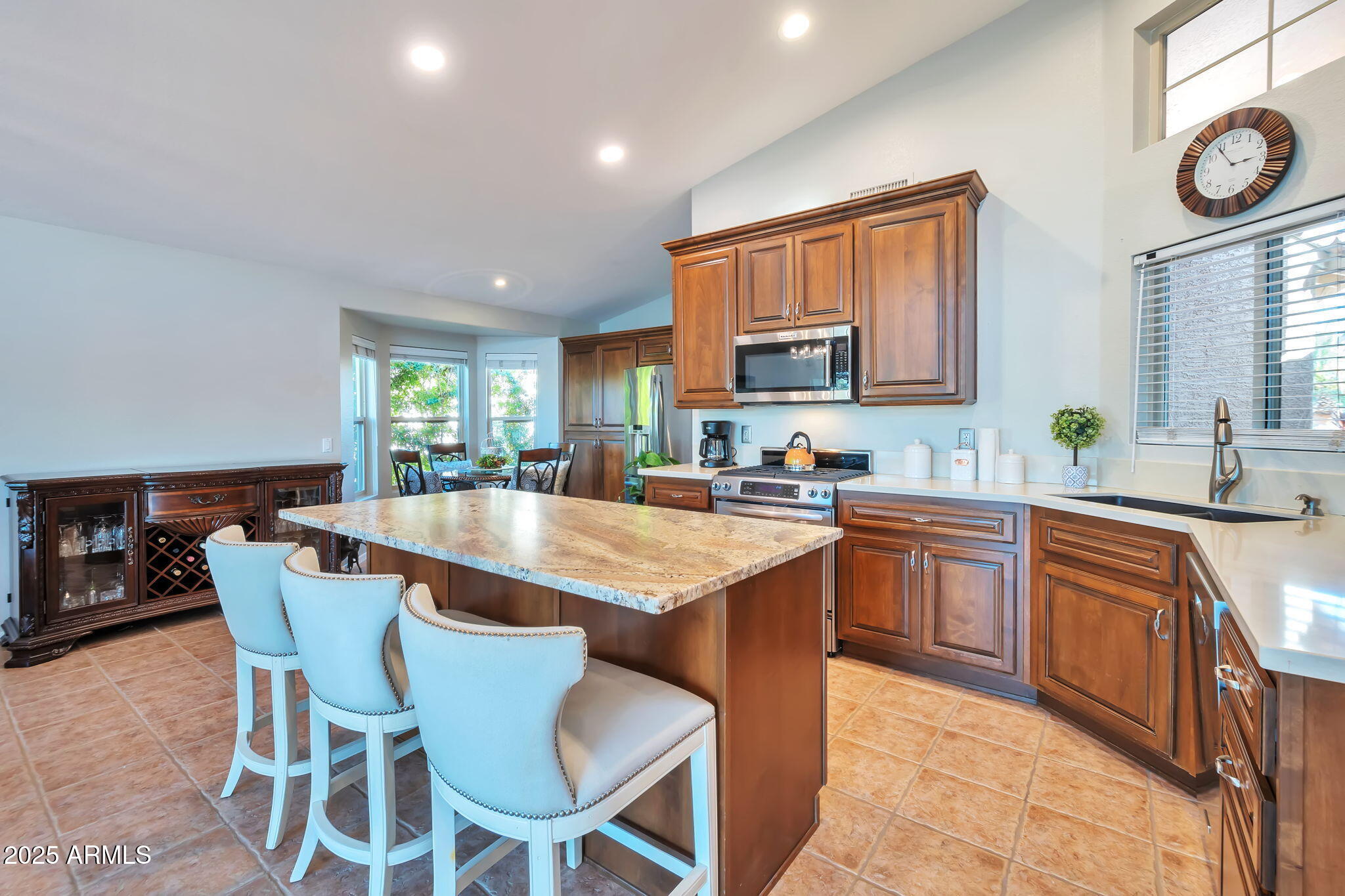 15460 West Merrell Street Goodyear, AZ 85395 - Photo 9 of 30 a kitchen with a dining table chairs and window