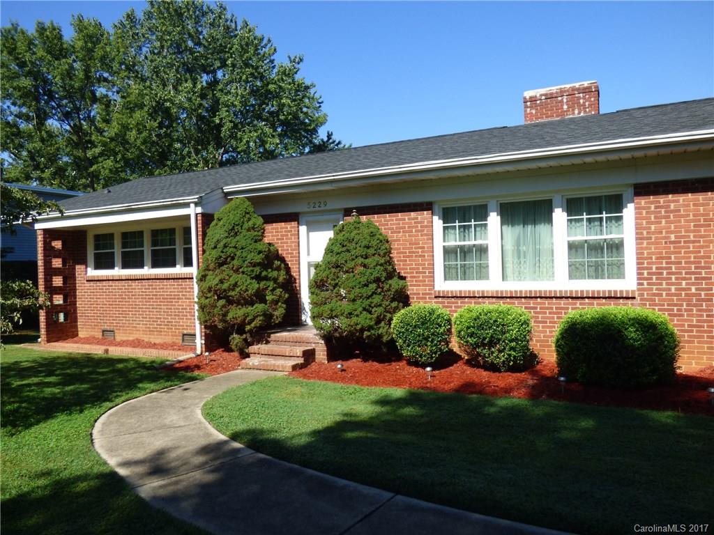 5229 Manning Road Charlotte, NC 28269 - Photo 1 of 18 a front view of a house with a yard