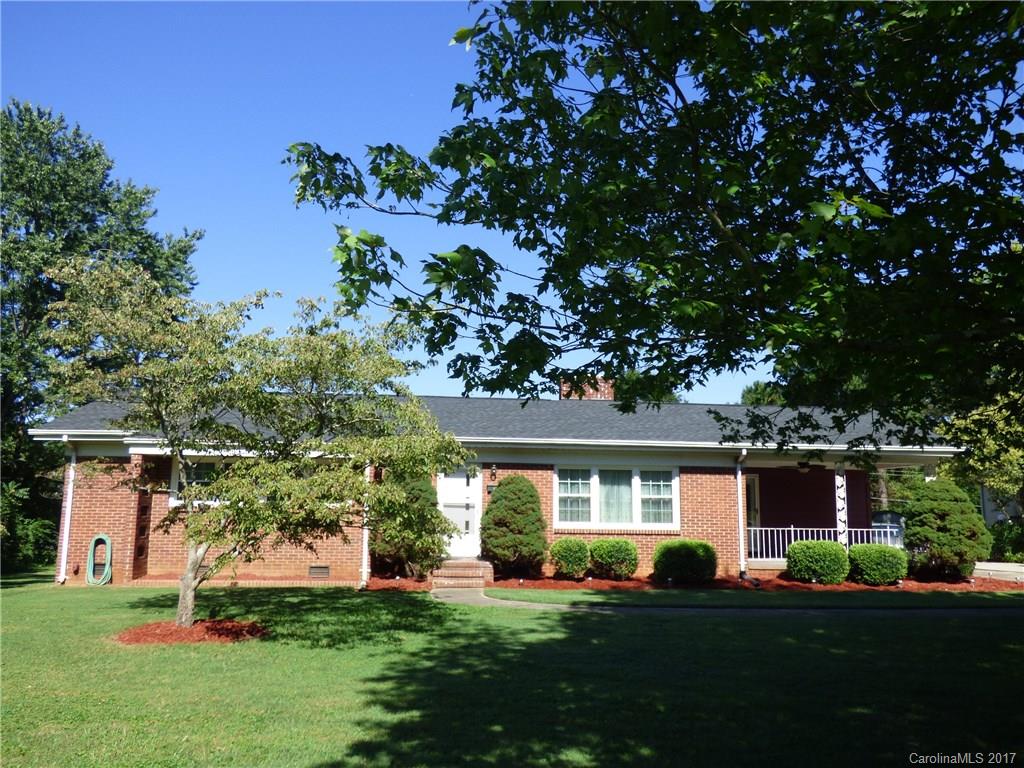 5229 Manning Road Charlotte, NC 28269 - Photo 2 of 18 a front view of a house with a yard and trees