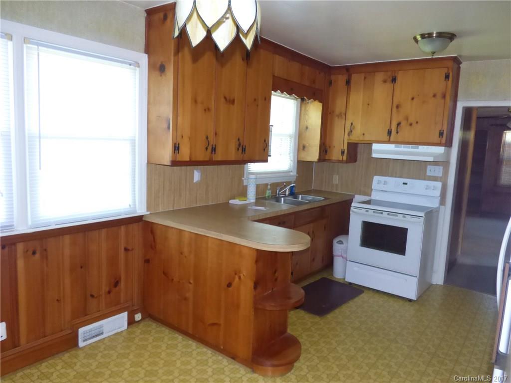 5229 Manning Road Charlotte, NC 28269 - Photo 11 of 18 a kitchen with a sink cabinets and a fireplace