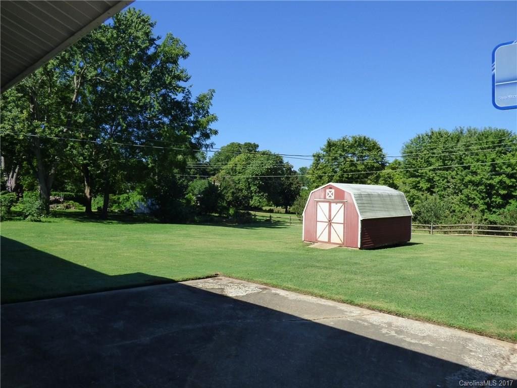 5229 Manning Road Charlotte, NC 28269 - Photo 17 of 18 a view of a field of grass and trees