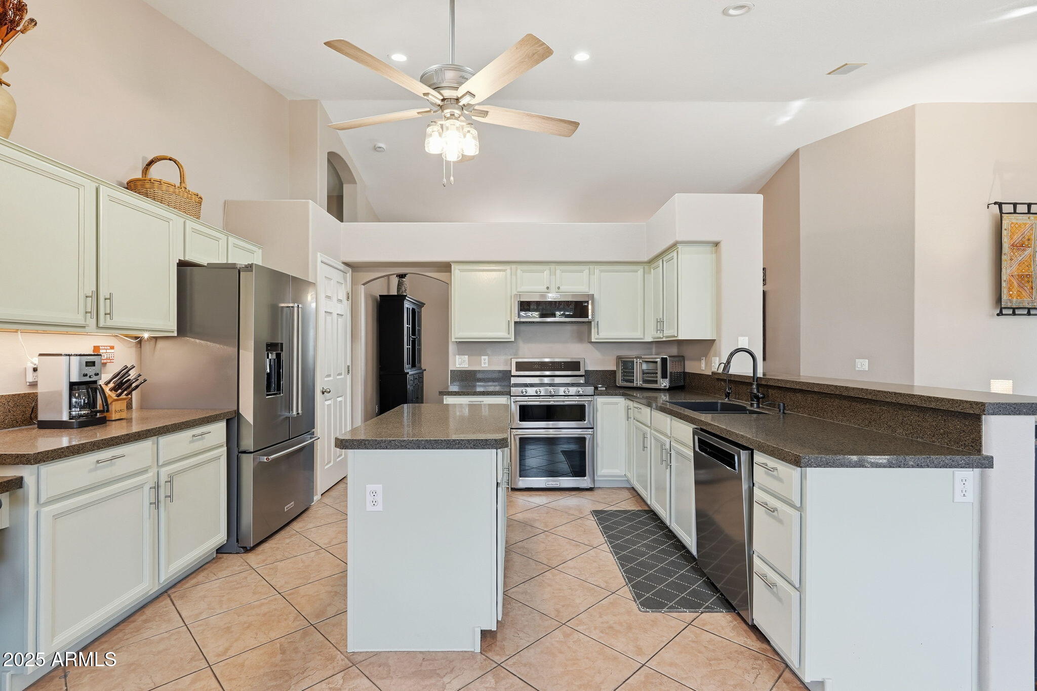 7137 East Laguna Azul Avenue Mesa, AZ 85209 - Photo 18 of 58 a kitchen with stainless steel appliances granite countertop a sink and cabinets