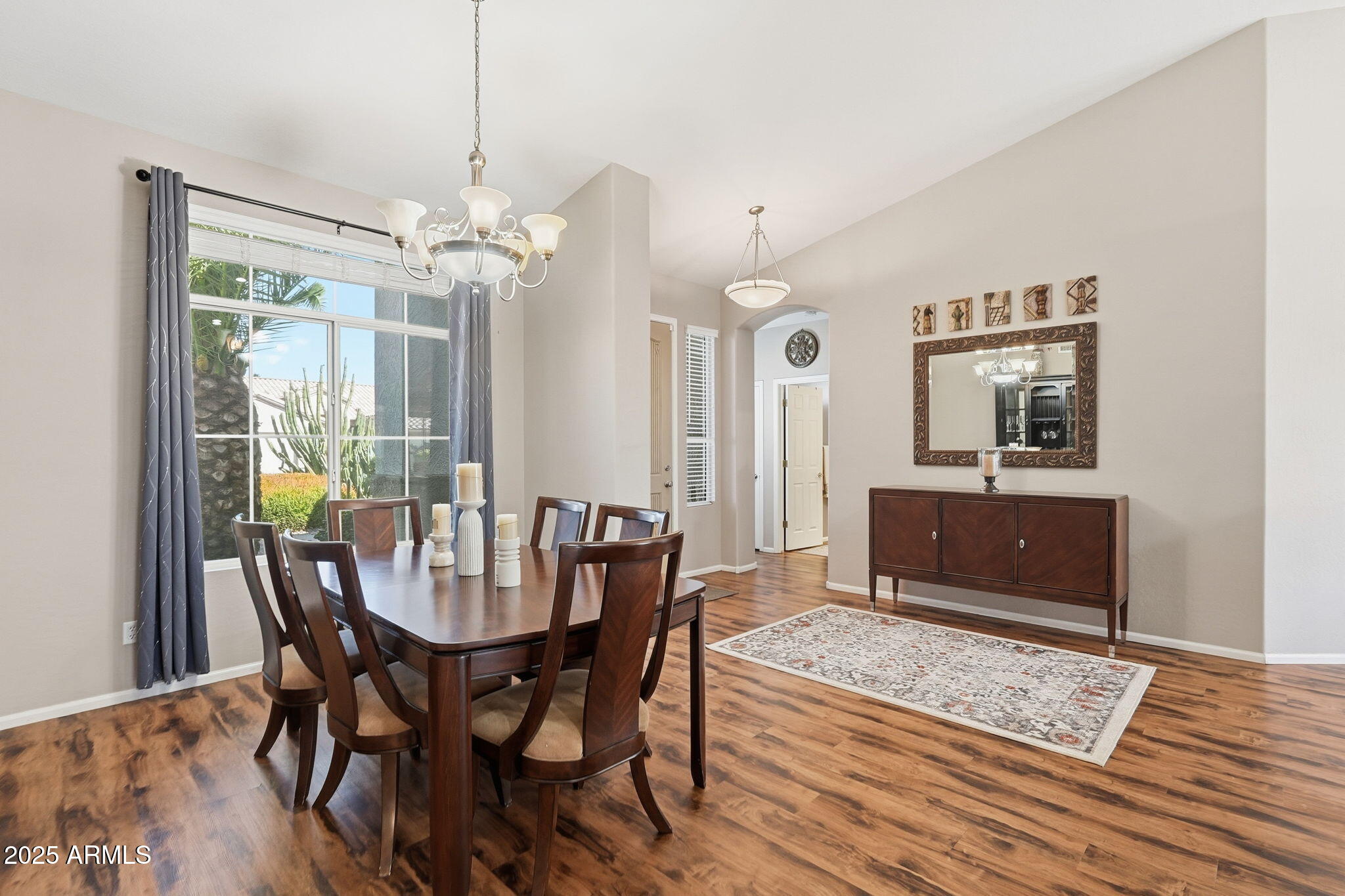 7137 East Laguna Azul Avenue Mesa, AZ 85209 - Photo 21 of 58 a view of a dining room with furniture window and wooden floor
