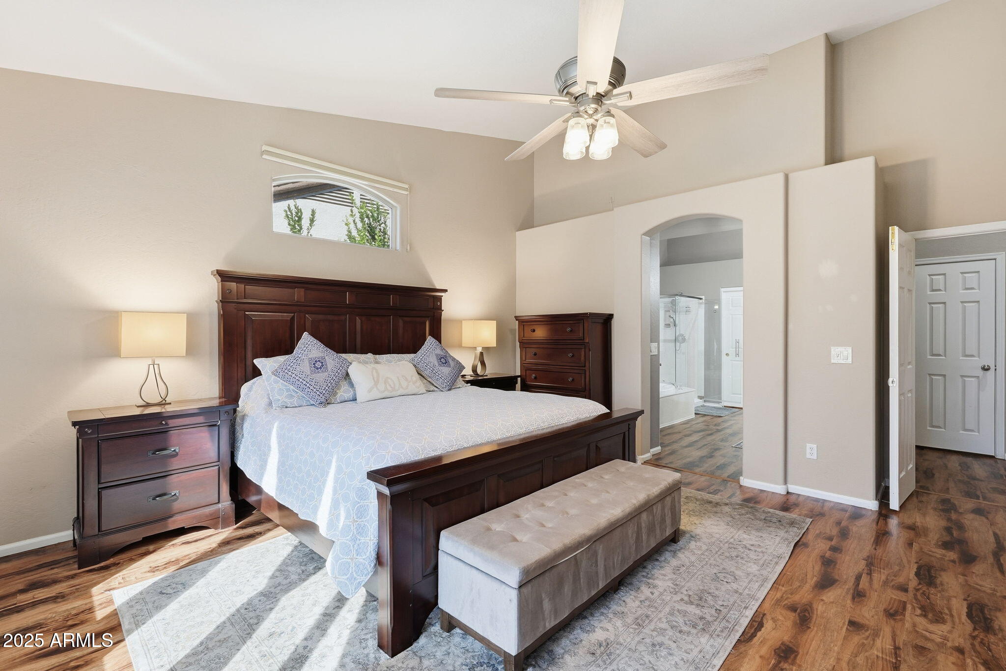 7137 East Laguna Azul Avenue Mesa, AZ 85209 - Photo 26 of 58 a bedroom with a bed and a chandelier