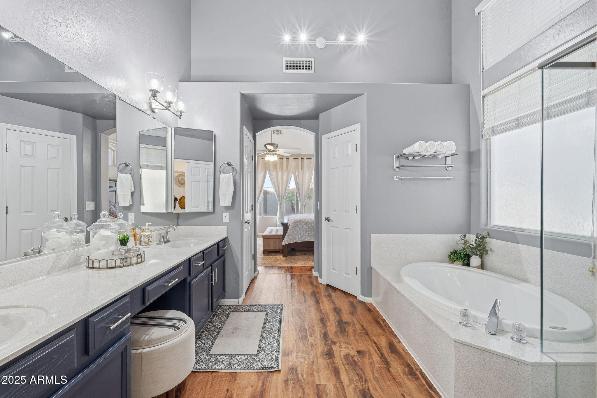 7137 East Laguna Azul Avenue Mesa, AZ 85209 - Photo 31 of 58 a spacious bathroom with a tub sink a toilet and mirror
