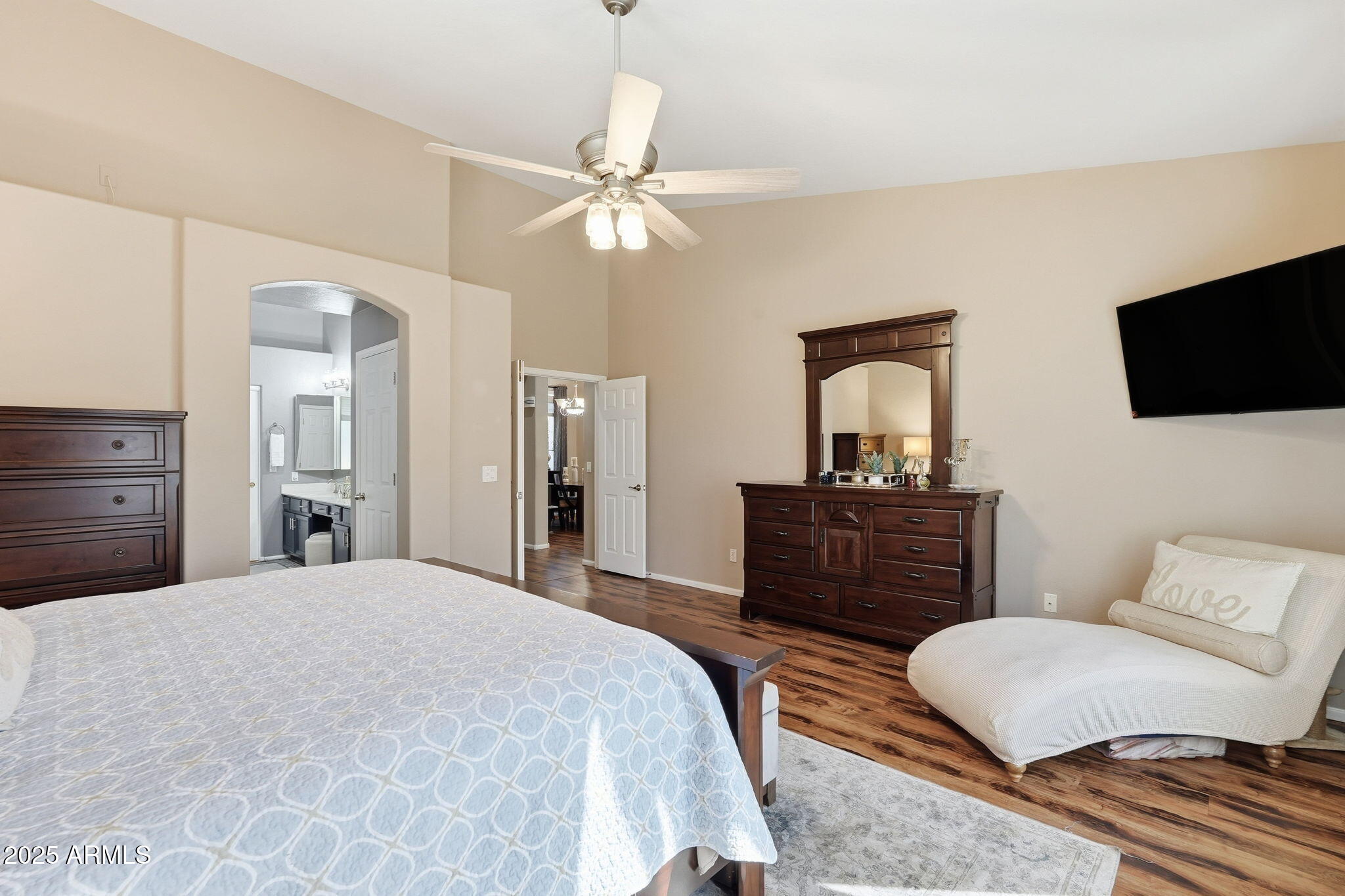 7137 East Laguna Azul Avenue Mesa, AZ 85209 - Photo 32 of 58 a bedroom with a bed and a flat screen tv