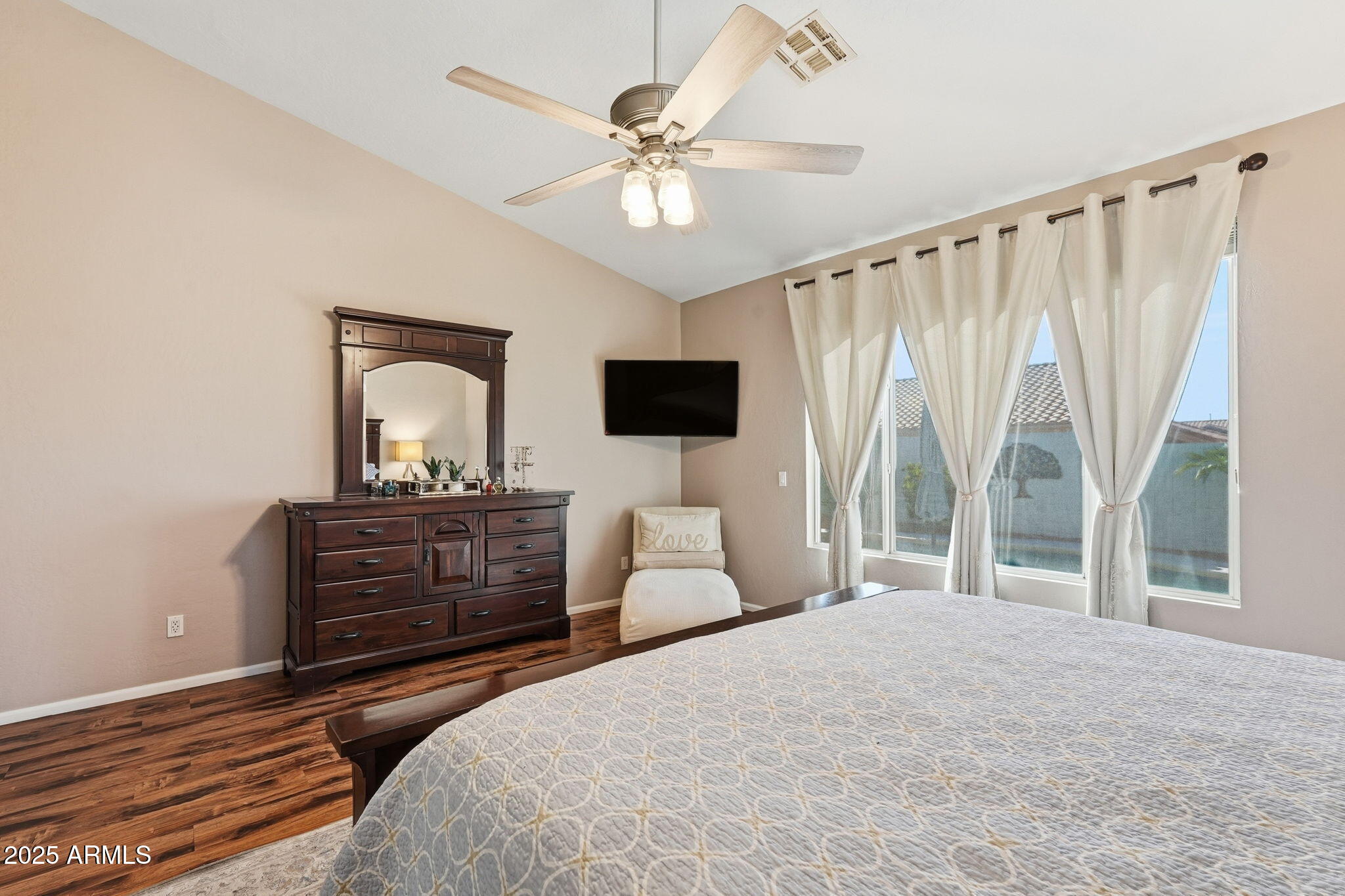 7137 East Laguna Azul Avenue Mesa, AZ 85209 - Photo 33 of 58 a bedroom with a bed flat screen tv and a large mirror