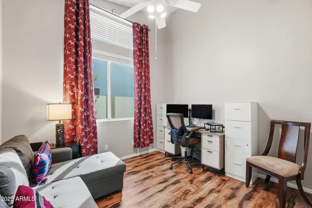 a bedroom with a bed and a large window