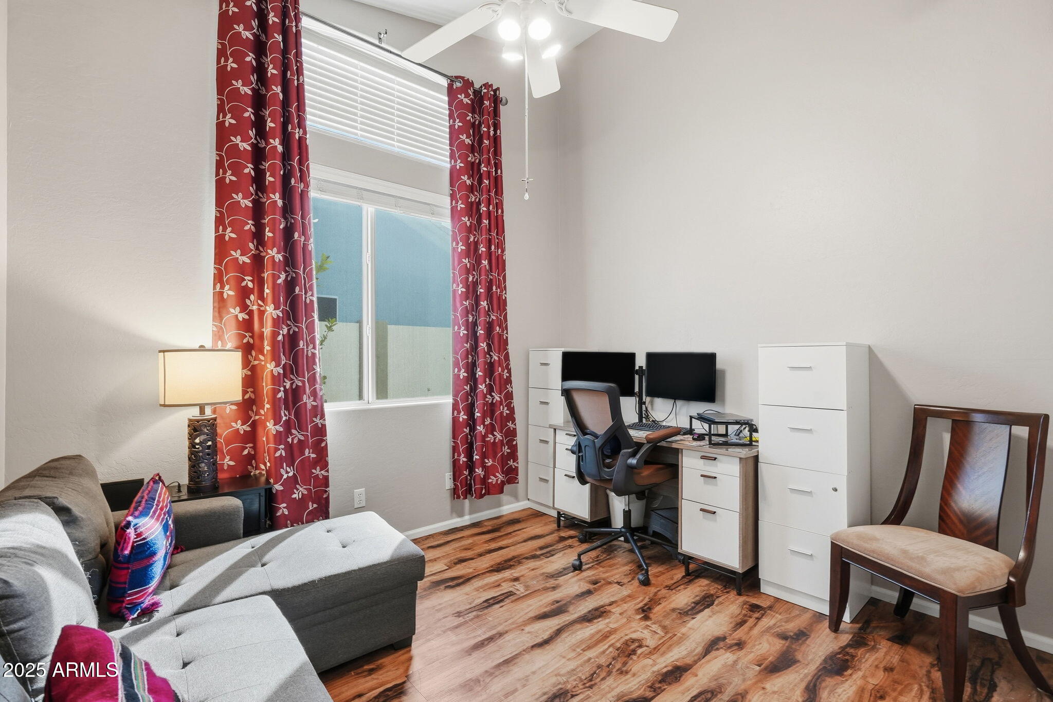 7137 East Laguna Azul Avenue Mesa, AZ 85209 - Photo 34 of 58 a bedroom with a bed and a chair