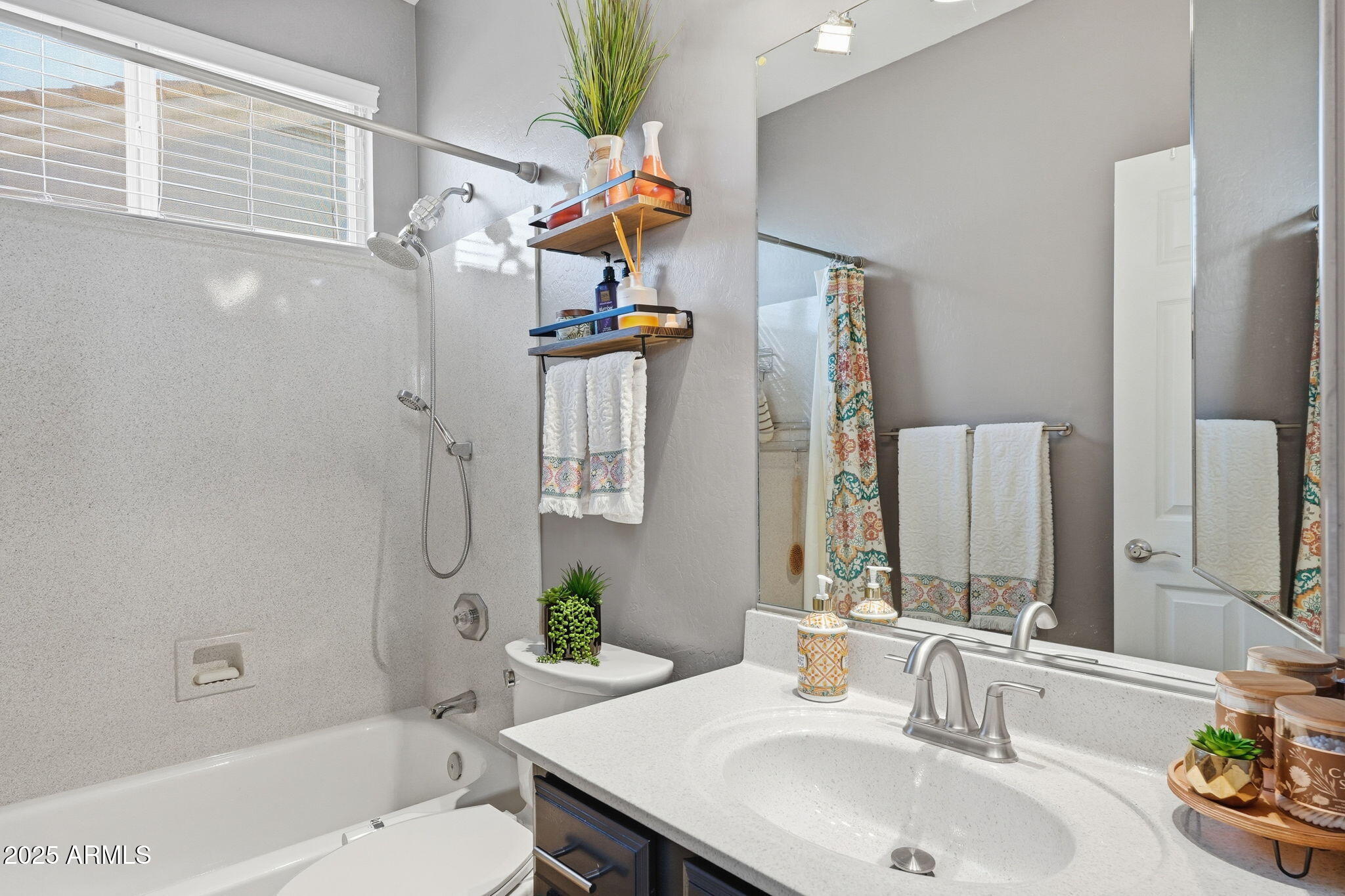 7137 East Laguna Azul Avenue Mesa, AZ 85209 - Photo 39 of 58 a bathroom with a sink toilet and shower