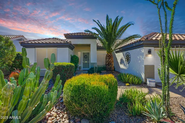 a front view of a house with garden