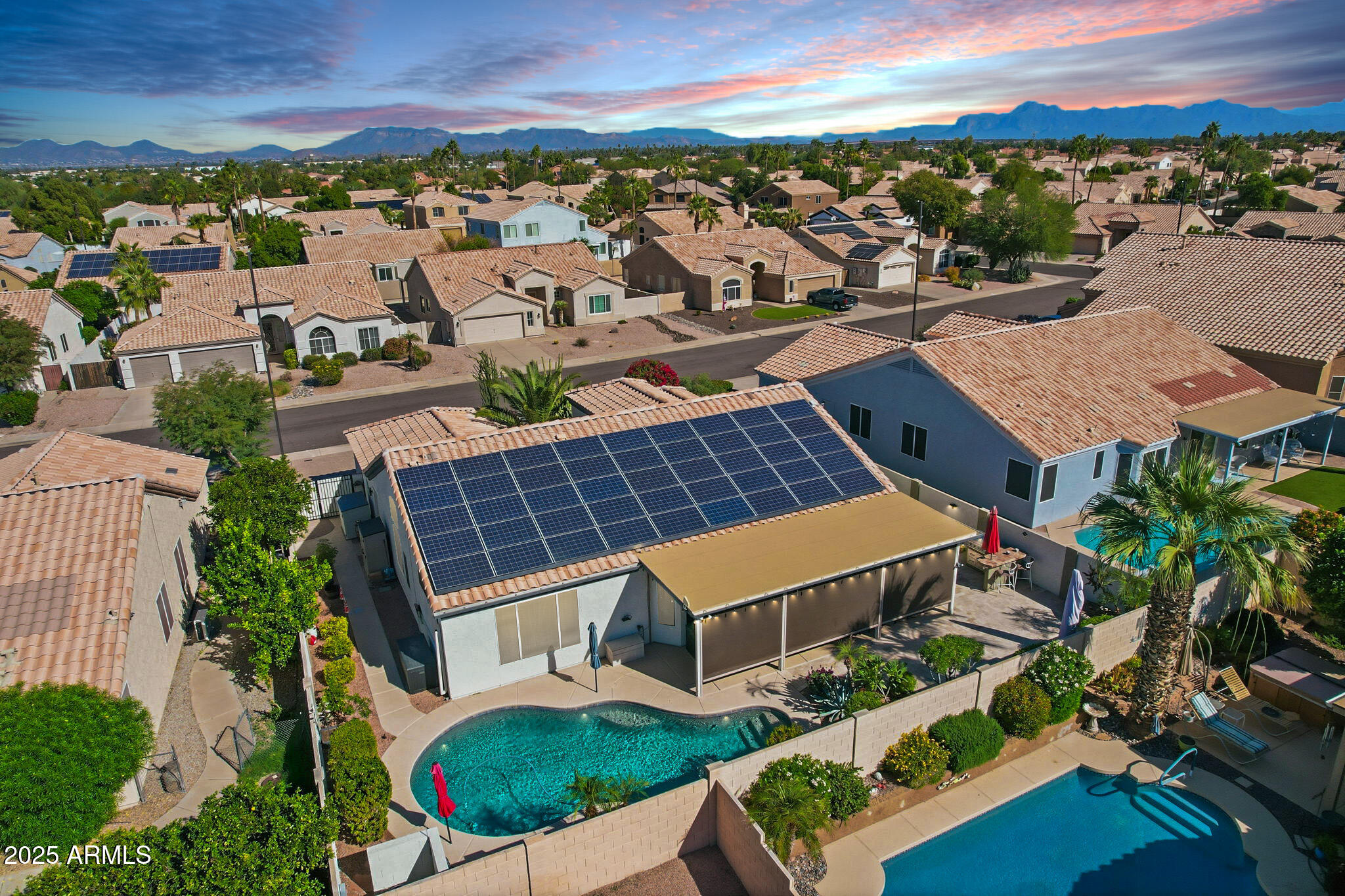 7137 East Laguna Azul Avenue Mesa, AZ 85209 - Photo 42 of 58 an aerial view of multiple houses with a yard