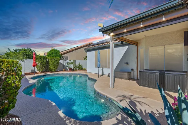 a view of house with garden space and swimming pool
