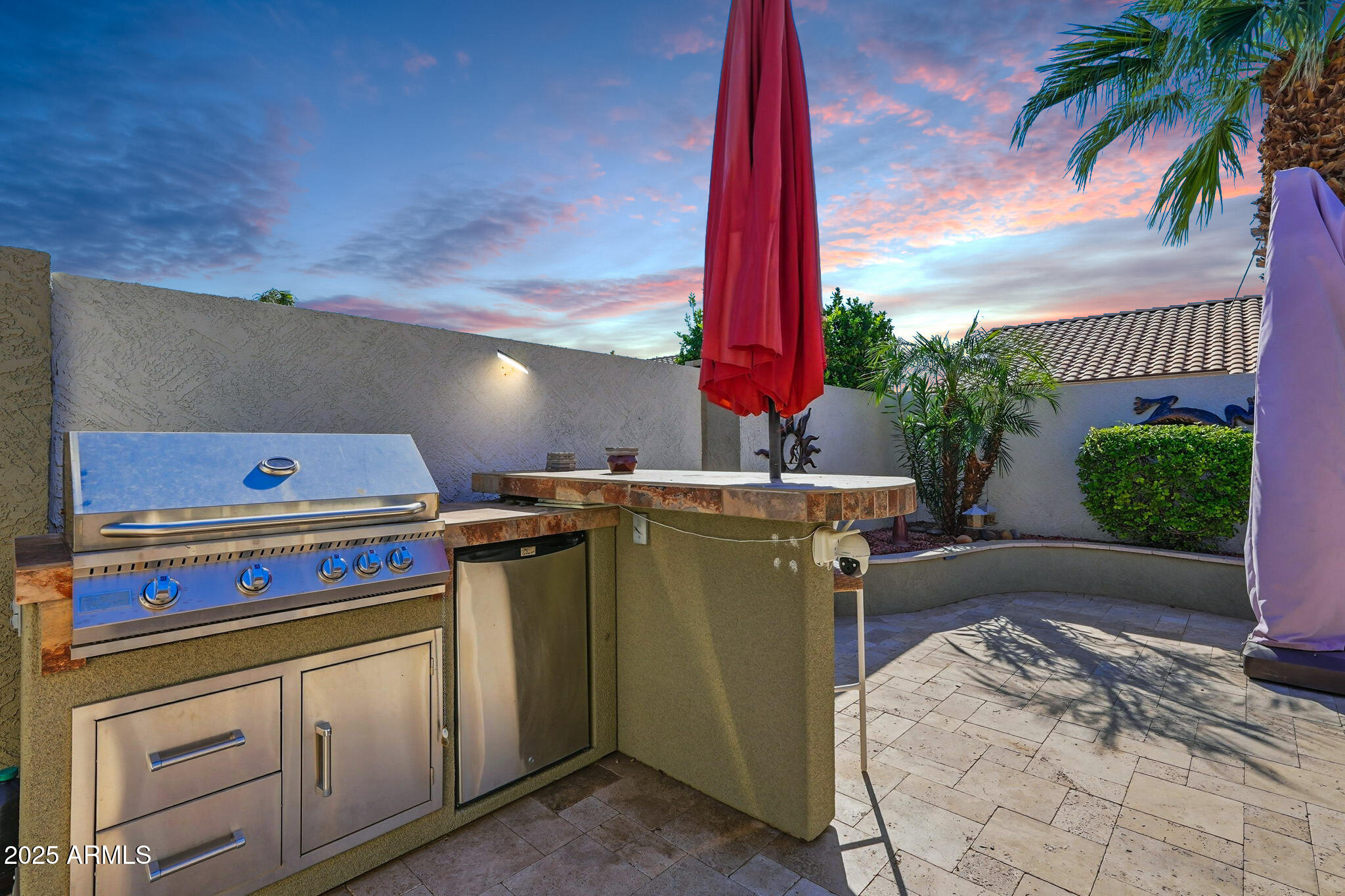 7137 East Laguna Azul Avenue Mesa, AZ 85209 - Photo 46 of 58 a open kitchen with a stove and a potted plant