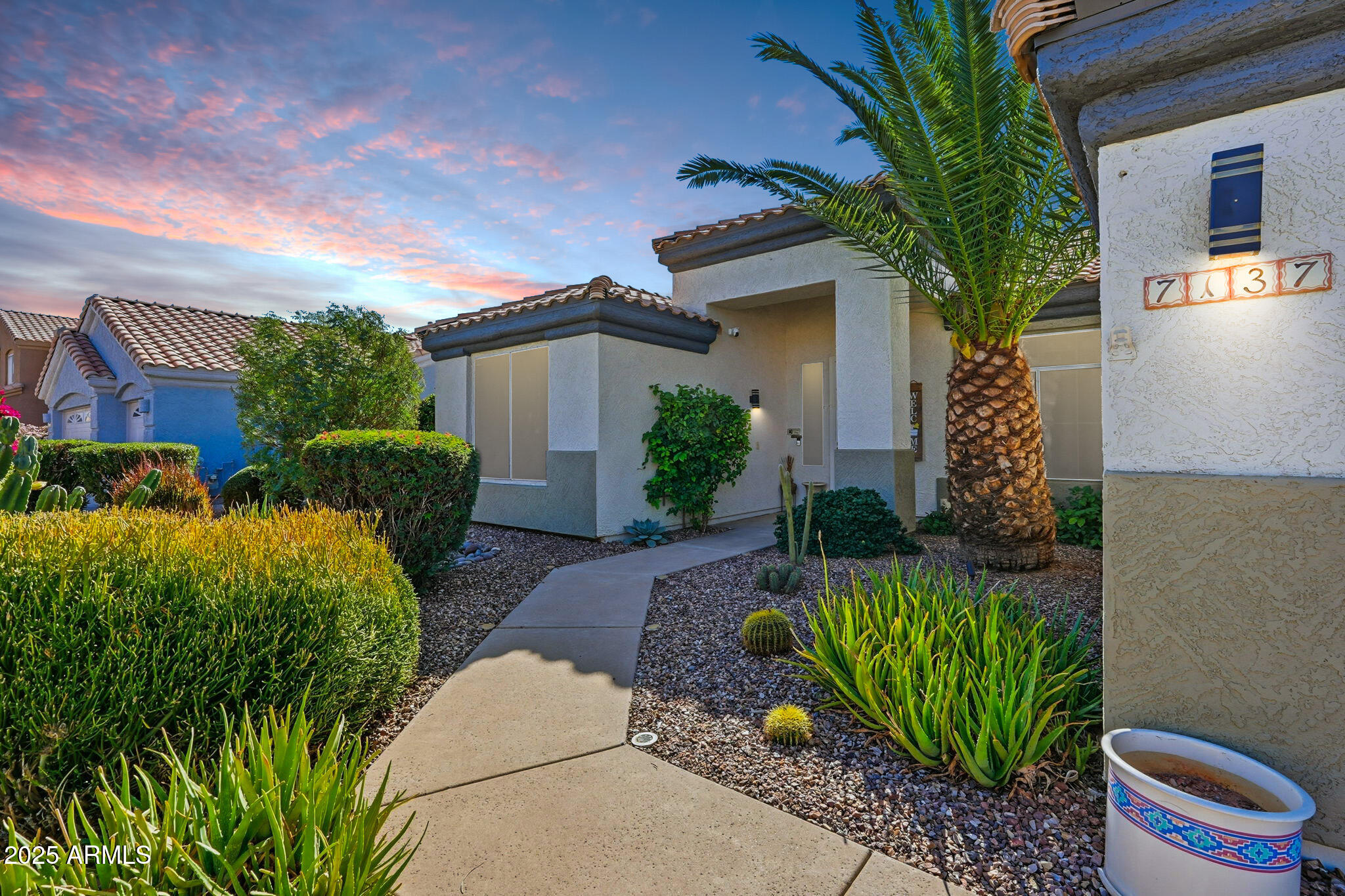 7137 East Laguna Azul Avenue Mesa, AZ 85209 - Photo 5 of 58 a front view of a house with garden