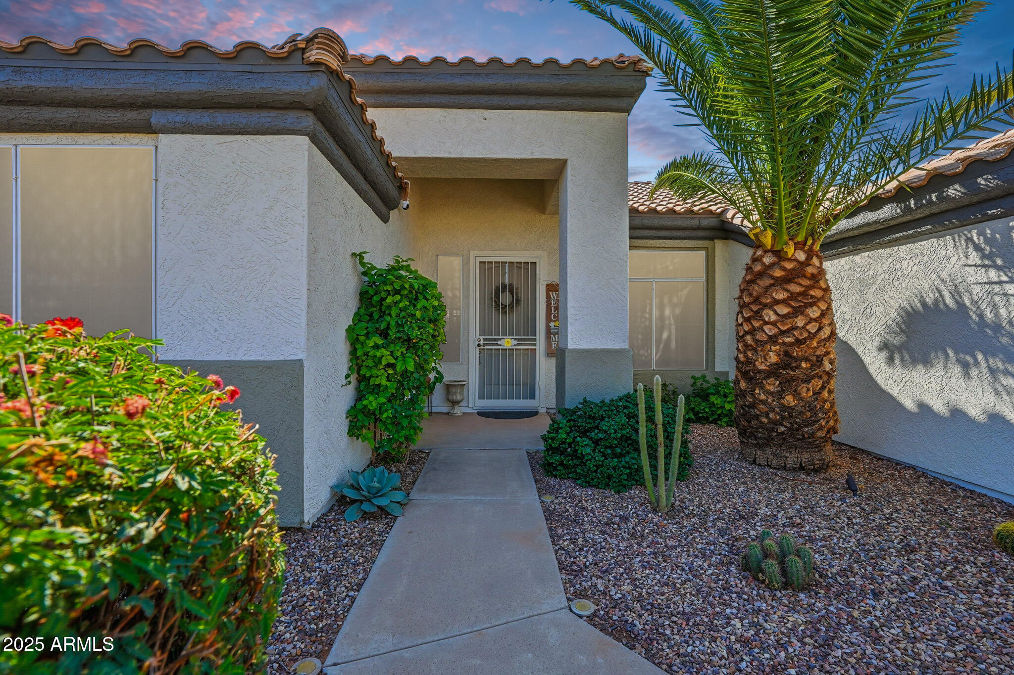 7137 East Laguna Azul Avenue Mesa, AZ 85209 - Photo 6 of 58 a front view of a house with a garden