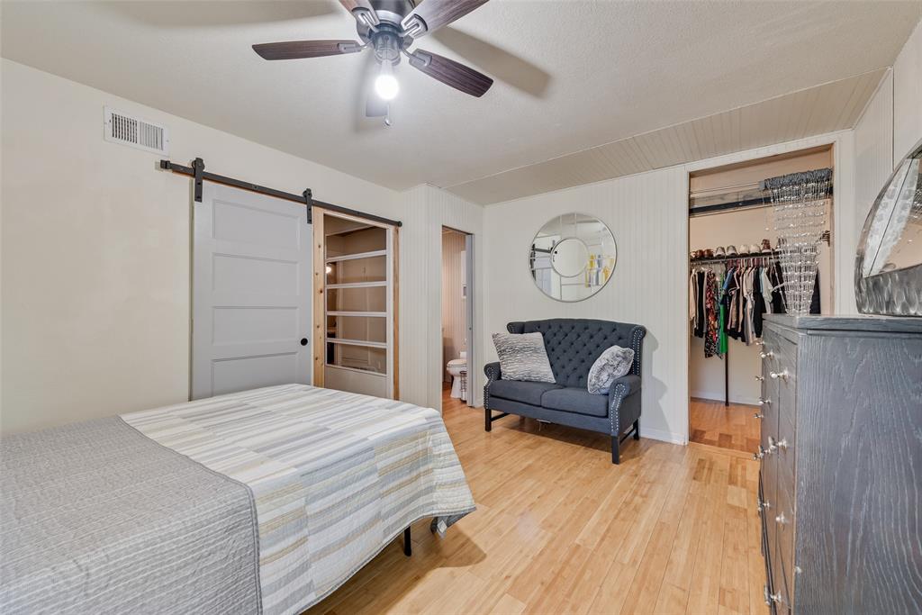 10605 Ferguson Road Dallas, TX 75228 - Photo 11 of 27 a bedroom with a bed and ceiling fan