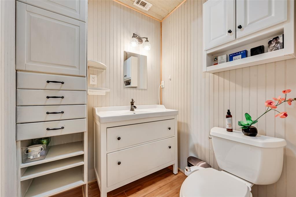 10605 Ferguson Road Dallas, TX 75228 - Photo 13 of 27 a bathroom with a sink a toilet and vanity