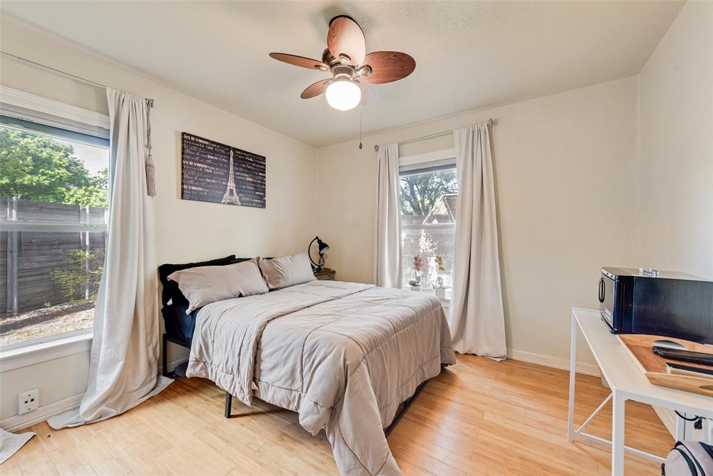 10605 Ferguson Road Dallas, TX 75228 - Photo 14 of 27 a bedroom with a bed and a flat screen tv