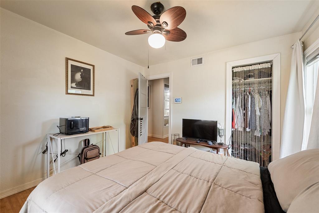 10605 Ferguson Road Dallas, TX 75228 - Photo 15 of 27 a bedroom with a bed and a flat screen tv