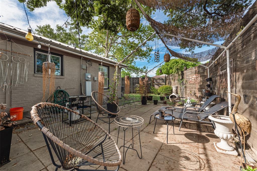 10605 Ferguson Road Dallas, TX 75228 - Photo 20 of 27 a view of a patio with a dining table and chairs with wooden fence