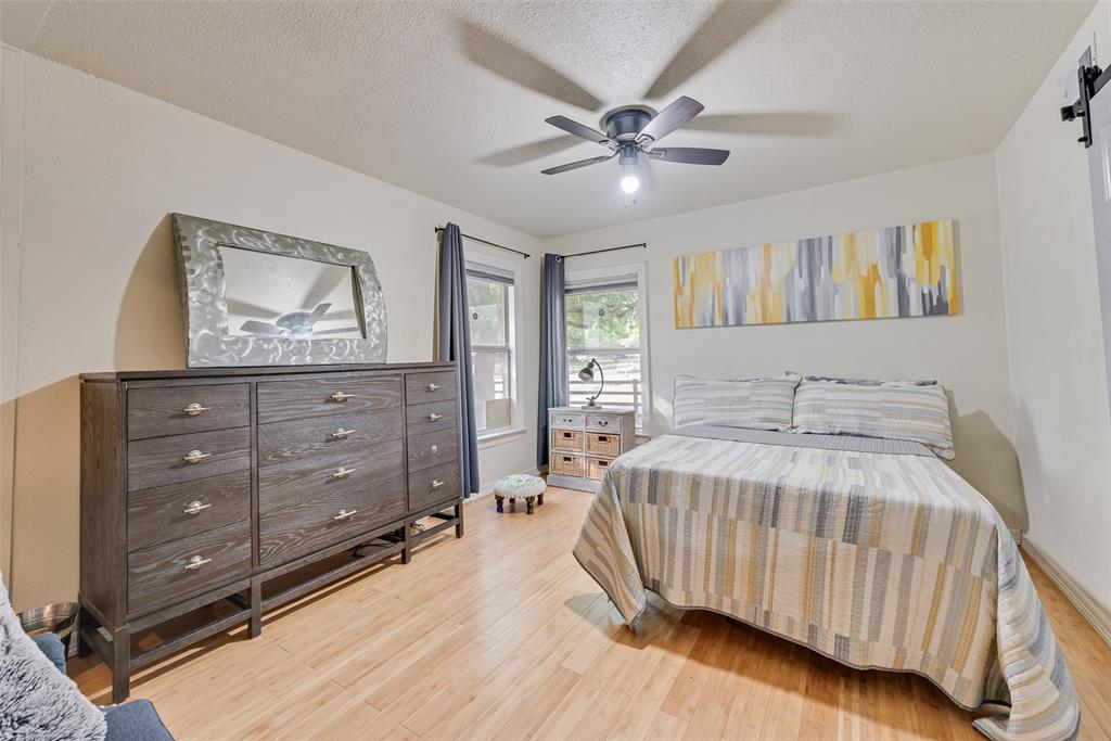 10605 Ferguson Road Dallas, TX 75228 - Photo 10 of 27 a bedroom with a bed and a dresser
