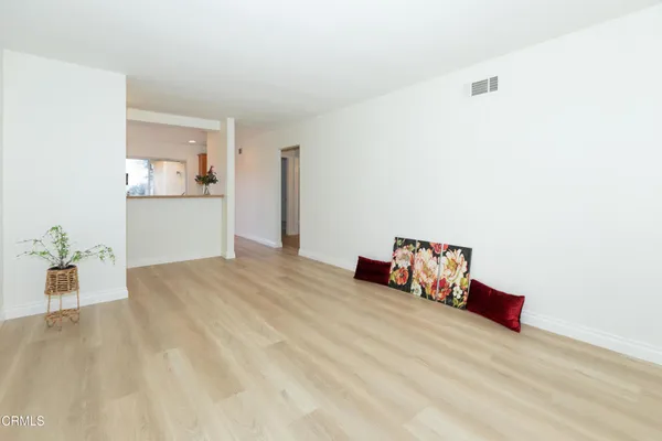 a room with a bed and dresser