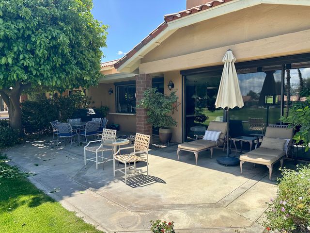 a view of a patio with table and chairs and potted plants