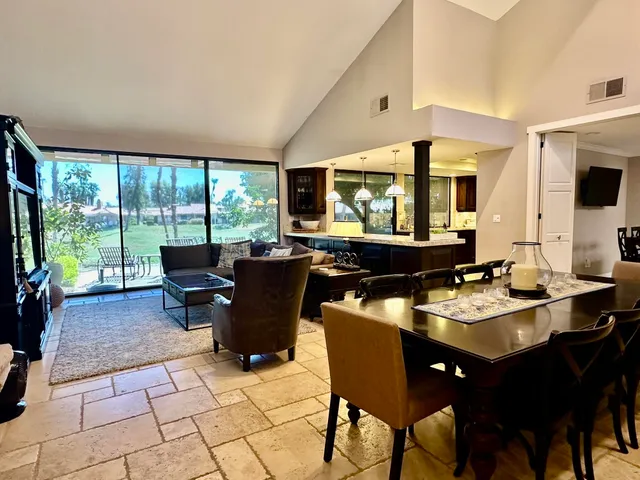 a living room with furniture and a floor to ceiling window