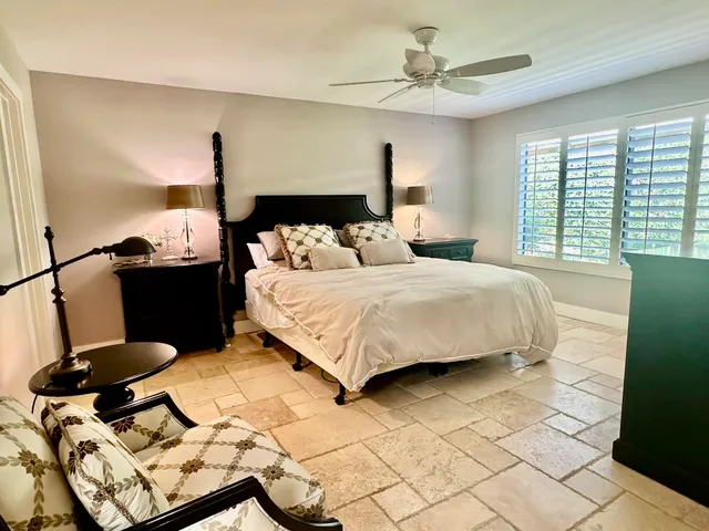 a spacious bathroom with a mirror sink and toilet