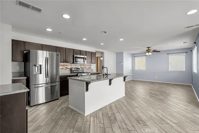 a kitchen with a refrigerator and a sink