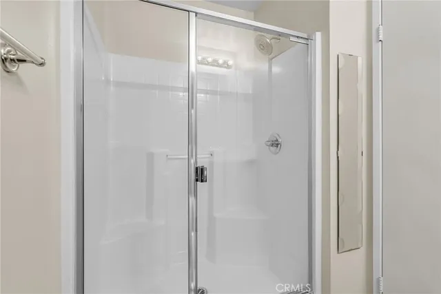 a bathroom with a glass shower door