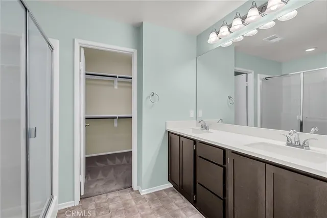 a bathroom with a double vanity sink and a mirror