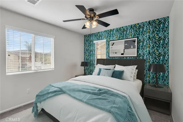 a bedroom with a bed and a large mirror