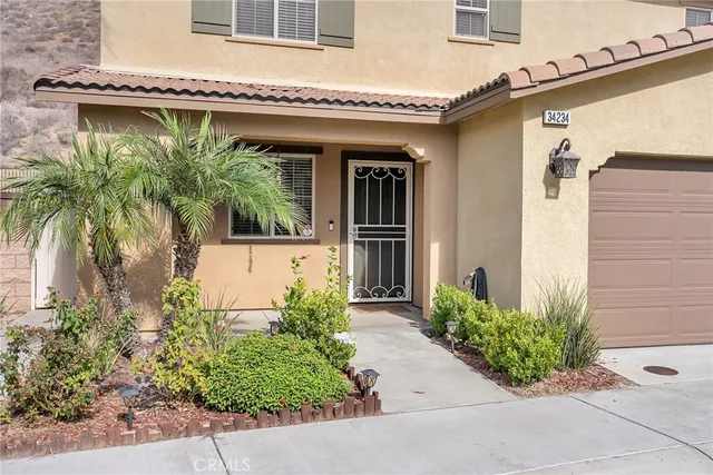 front view of a house with potted plants
