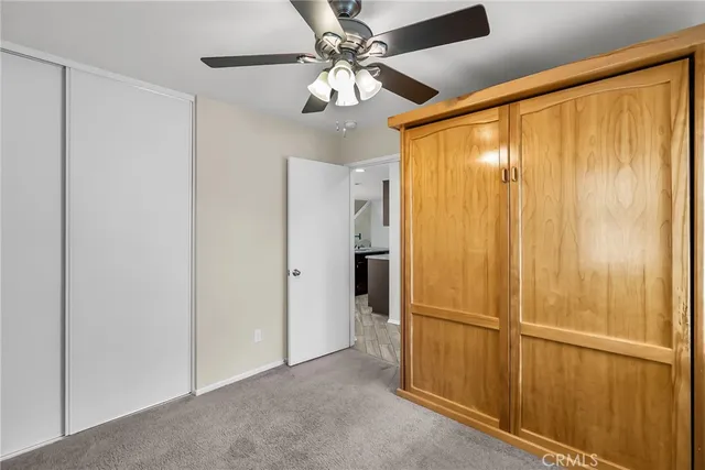a view of a room with window and a ceiling fan