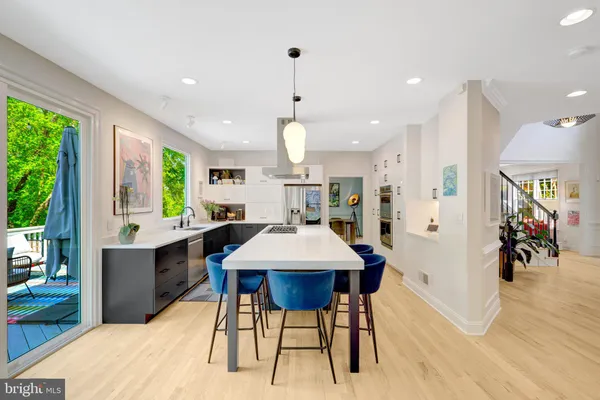 a large kitchen with stainless steel appliances a large island in the center