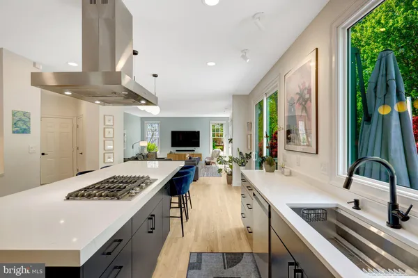 a kitchen with kitchen island a sink dining table and chairs