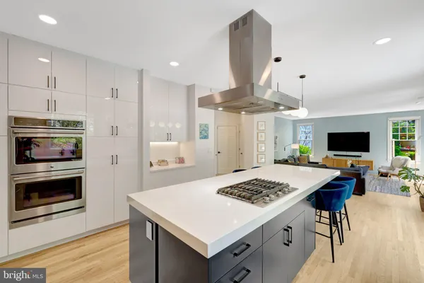 a kitchen with a table chairs stove and cabinets