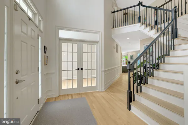 a view of entryway with wooden floor and stairs