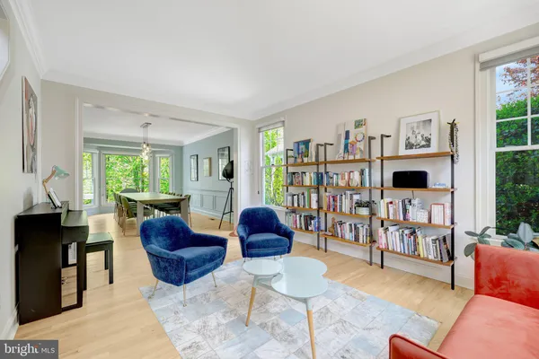 a living room with furniture and a book shelf