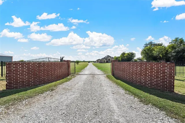 a view of a pathway with a wrought fence