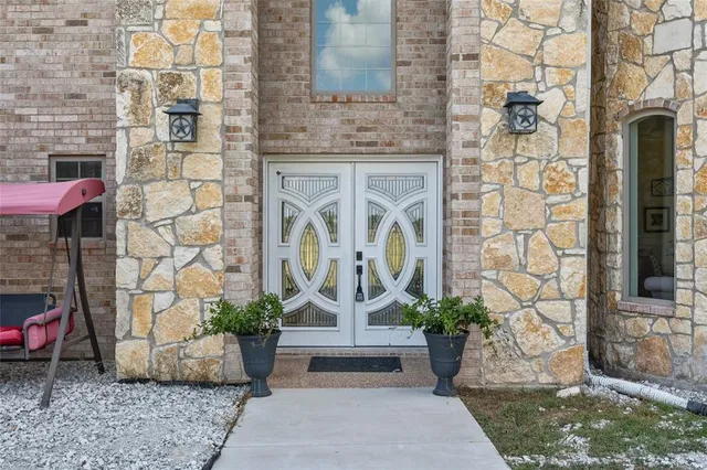 a view of a brick house with potted plants