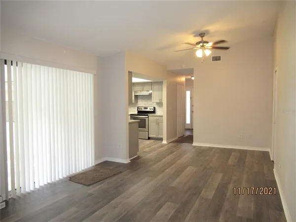 a view of a kitchen with wooden floor and a kitchen