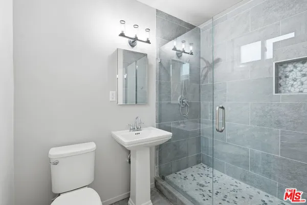 a bathroom with a sink toilet and shower