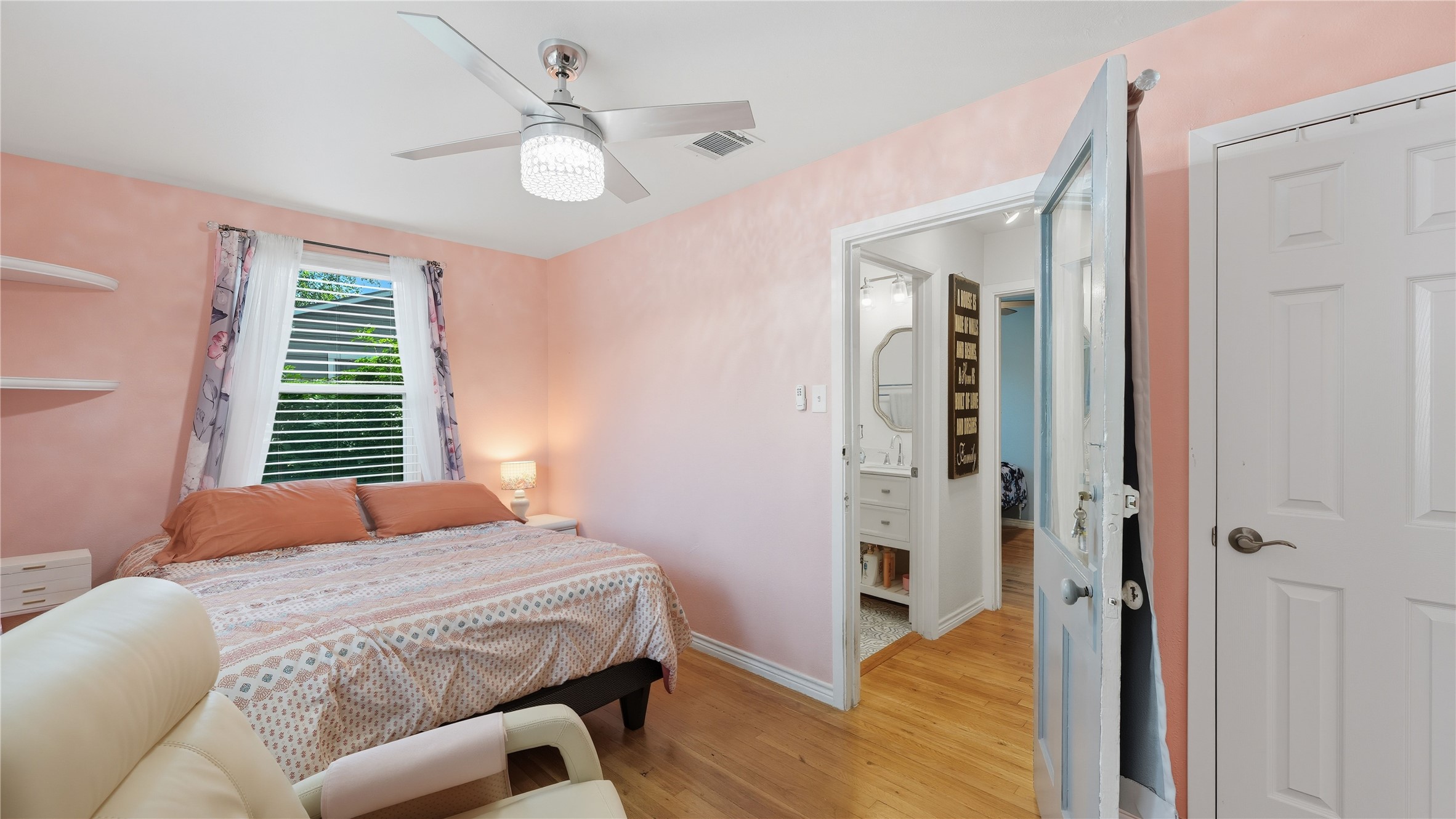 6503 Lynch Lane Austin, TX 78741 - Photo 26 of 38 a bedroom with a bed and a chandelier